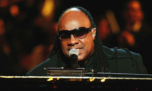 Stevie Wonder singing at concert
