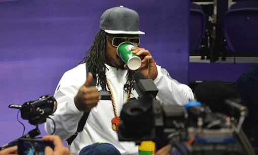 Marshawn Lynch drinking from cup at press conference