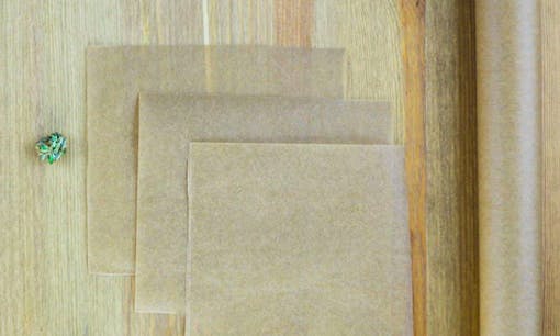 Parchment pape on table next to cannabis flower