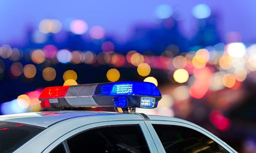 Police car lights overlooking city