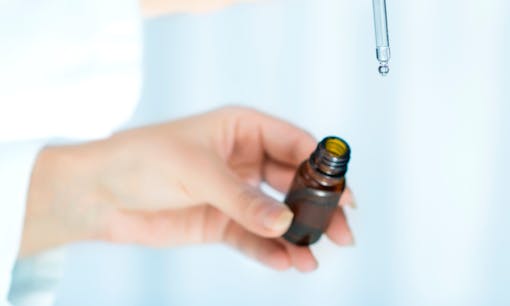 Man holding medical vial