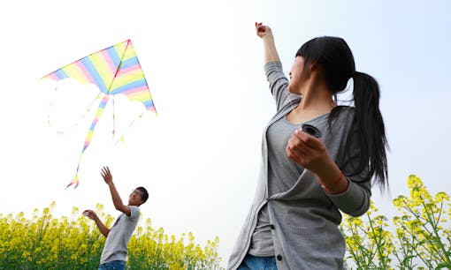 Couple flying kite near the beach