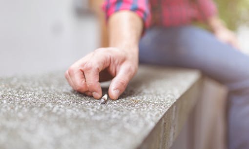 Man holding cannabis joint outside