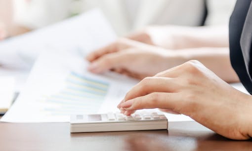 Person's hand on a calculator