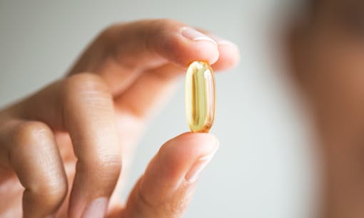 Woman holding capsule