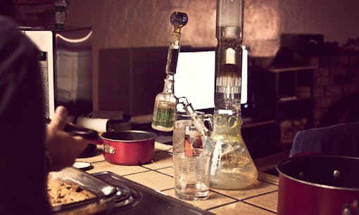 Dirty bong on messy apartment counter