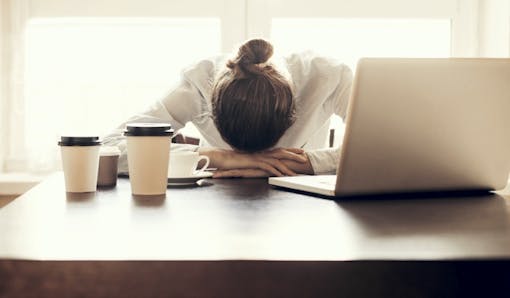Tired woman at her work desk