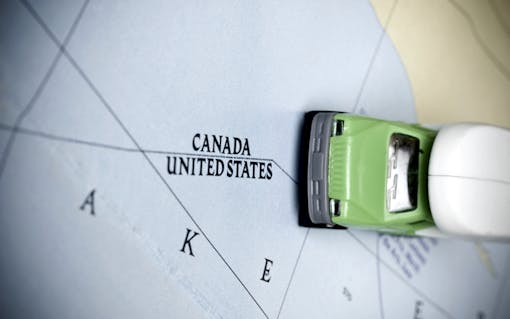 Canada - U.S. map border with a little toy car