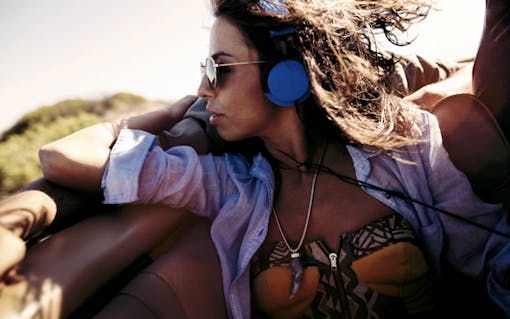 Woman listening to music during a road trip