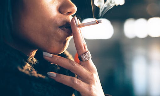 Woman puffs on cannabis joint