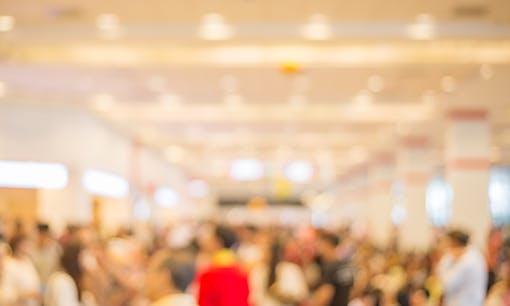 Blurred image of a crowded room at a convention