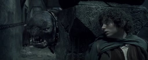 Cave troll stalking Frodo in The Fellowship of the Rings