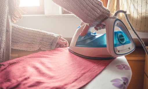 Woman ironing sheets