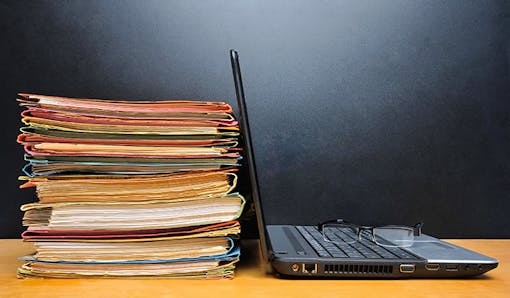 Laptop and stack of files