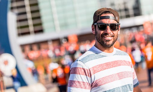 Former NFL player Nate Jackson smiling at a tailgate for the Denver Broncos with Leafly