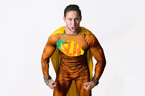 Man wearing orange and yellow superhero costume with "SLH" insignia on chest