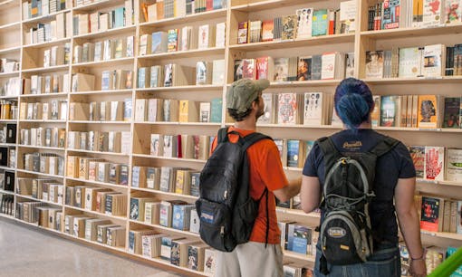 Patrons browsing bookshelves at Powell's City of Books in Portland, Oregon