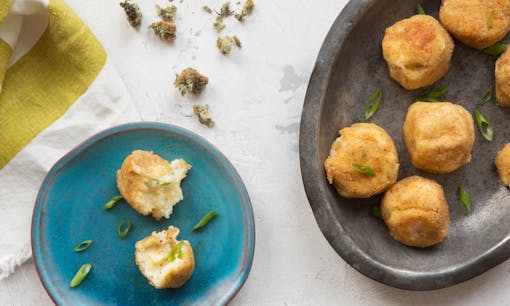 Cannabis-infused mac n' cheese ball edibles on plates next to cannabis flower