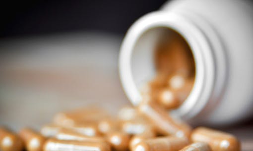 Ingestible cannabis oil capsules falling out of jar