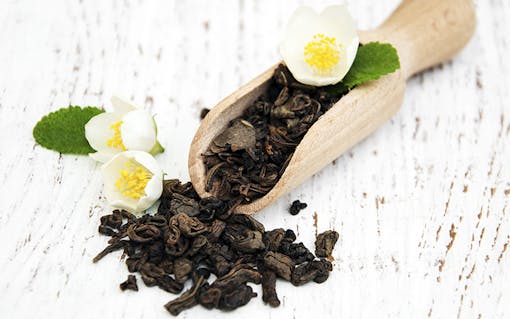 Dry green tea leaves with jasmine flowers