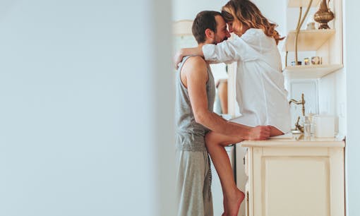 A man and woman embracing at home