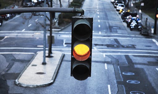 Yellow traffic light in city
