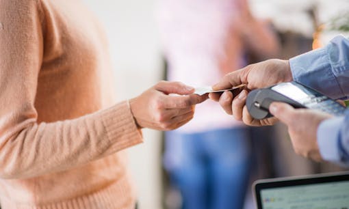 Woman taking her card back from cashier
