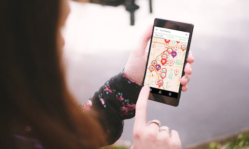 Woman using Leafly's dispensary finder on her smartphone