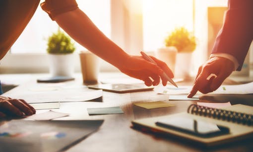 Two business people reviewing paperwork