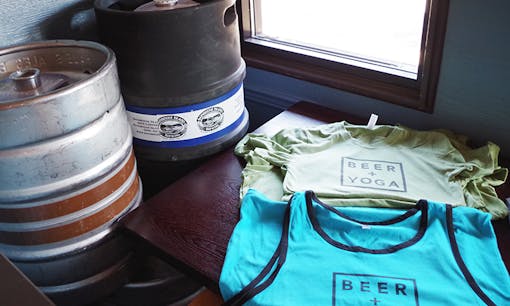 Beer + Yoga t-shirts next to kegs