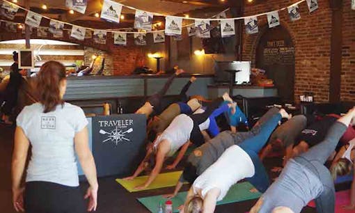 Group of people doing yoga at beer bar
