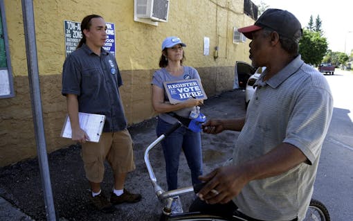 Volunteers walked neighborhood streets to register voters as Tuesday is the last day to register to vote in the general election Nov. 6. Monday, Oct. 8, 2012 in Miami. (AP Photo/Lynne Sladky)