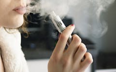 Photo of a woman using CBD vape juice