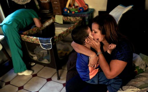 Before going to a Halloween event at Jacel Delgadillo's daughter's school, she and Bruno share a moment together in the family's living room in Miami, FL on Friday, October 28, 2016. "It’s like magic now," Delgadillo said about how attentive Bruno has become, "i honestly thought before that he didn’t know I was his mom. I feel like he knows now." By Scott McIntyre