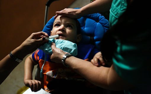 While they were out at the Halloween event, Bruno became sick and threw up, so Jacel Delgadillo decided it was best for him to leave after she gave him his CBD medicine (cannabis oil) with the help of their nurse Idania Gonzalez at Angelene's school in Miami, FL on Friday, October 28, 2016. During social events, Delgadillo has to keep extra close watch on Bruno. (Scott McIntyre for Leafly)