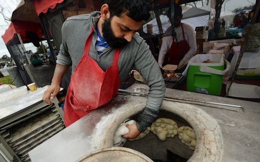 Naresh Kumar making nan at the Indian Gourmet stand during The Emerald Cup held at the Sonoma County Fairgrounds in Santa Rosa, California. (Erik Castro for Leafly)