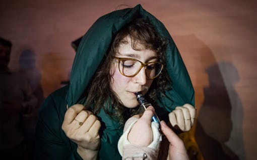 Erin Ingle dabbing at Gateway cannabis comedy show at Jai Thai in Capitol Hill, Seattle