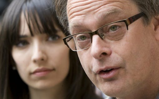 Marc Emery, the self-described "Prince of Pot" speaks to reporters outside the Supreme Court in Vancouver, British Columbia, in this 2010 photo,as his wife Jodie looks on. The couple was arrested in Toronto on Wednesday. (Jonathan Hayward/The Canadian Press via AP)