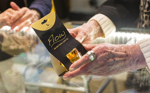 A visitor from Sound Vista Village holds a cannabis gel product while making a purchase at Vela Cannabis in Seattle, Washington on March 16, 2017. A group from Sound Vista Village, an assisted living facility in Gig Harbor, visited Vela Cannabis. (Photo by David Ryder/Leafly)