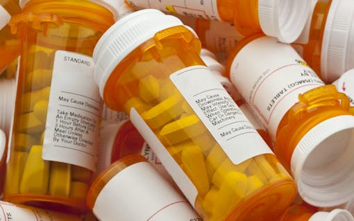 Several Prescription Pill Bottles in a Pile