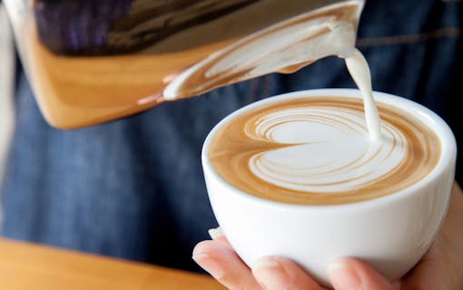 Pouring latte art into the cup
