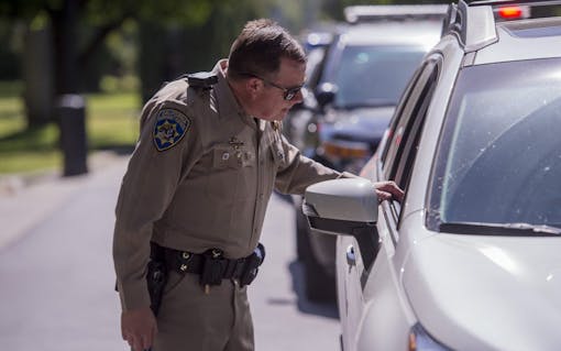 CHP officer Gary Martins conducts simulated traffic stop on Jaimi Kenyon, a CHP Sergent as members of the Highway Patrol and Sacramento Police Department simulate traffic stops involving drivers suspected of being under the influence of drugs and alcohol at the California State Capitol, Wednesday May 10, 2017. The demonstration will showed the current procedures used by law enforcement officers as well as new roadside drug testing technology that could be used in the future. Photo by photo by Brian Baer