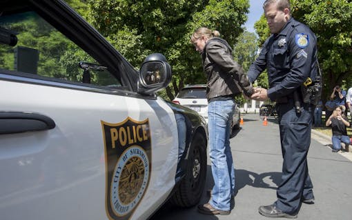 Sacramento Police officer Luke Moseley conducts simulated saliva field sobriety test on Jaimi Kenyon, a CHP Sergent as members of the Highway Patrol and Sacramento Police Department simulate traffic stops involving drivers suspected of being under the influence of drugs and alcohol at the California State Capitol, Wednesday May 10, 2017. The demonstration will showed the current procedures used by law enforcement officers as well as new roadside drug testing technology that could be used in the future. Photo by photo by Brian Baer