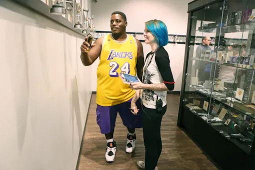 Customer Anthony Ramsey, left, of Las Vegas, receives guidance from staff member Aly Bessey at Oasis Medical Cannabis early Saturday morning. (Ronda Churchill for Leafly)