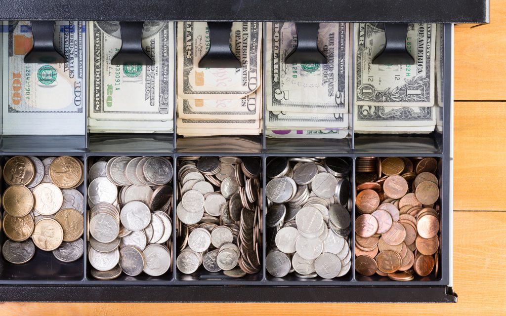 Top view of a single cash drawer that is fully stocked with