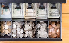 Top down view on single cash register drawer stocked full with