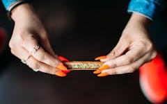 A picture of a woman rolling a blunt. Flavors blunt wraps are in the FDA crosshairs. (Adrienne Allen/Leafly)