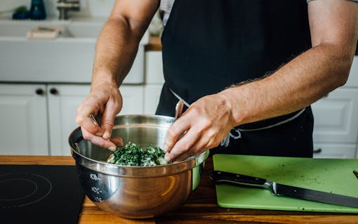 Chef Ryan Swartling mixes his apple slaw, which complements both of his infused barbecue recipes.