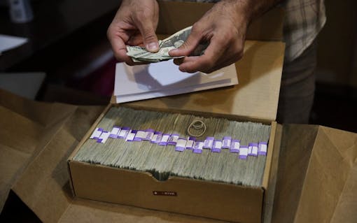 Los Angeles legal cannabis consumers will pay an estimated $128 million to the city in 2021. Above, a 2017 AP file photo of a dispensaries' monthly tax payment. (AP Photo/Jae C. Hong,File)