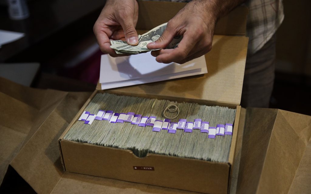 Los Angeles legal cannabis consumers will pay an estimated $128 million to the city in 2021. Above, a 2017 AP file photo of a dispensaries' monthly tax payment. (AP Photo/Jae C. Hong,File)